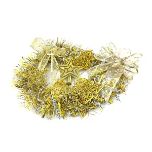Detailed macro view of gold and silver Christmas tinsel wreath with stars and bells