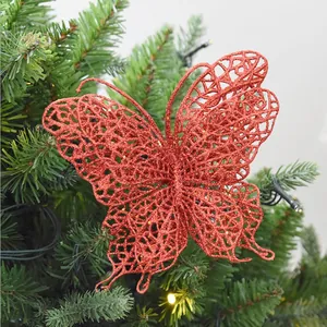 Close-up showing the intricate glittery texture of a red Christmas butterfly