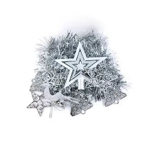 Detail view of silver Christmas tree ornaments set with stars and tinsel