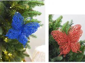 Detail of blue and red glitter butterfly ornaments hanging on a Christmas tree.
