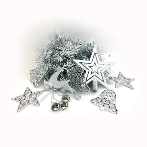 Assorted silver Christmas tree ornaments including stars, bells, and reindeer decorations