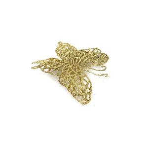 Detailed macro view of a golden glittery PVC butterfly ornament for Christmas tree decor