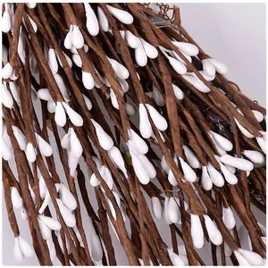 Macro detail of artificial berry rattan featuring white teardrop berries and brown vines