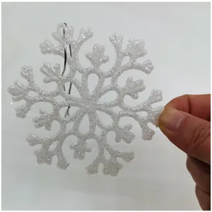 Macro view of a 10cm white glittery acrylic snowflake ornament for Christmas decor