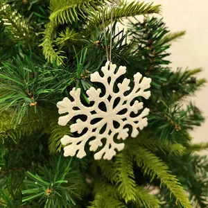 Detailed view of a 10cm white glittery acrylic snowflake hanging on a Christmas tree