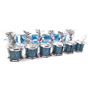 Détail de mini tambours et boîtes cadeaux bleus scintillants pour décorer le sapin de Noël