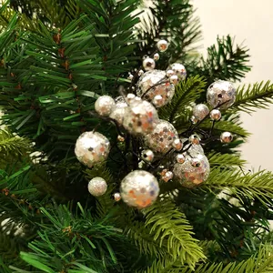 Detailopname van glanzende zilveren glitter bessenclusters op een kerstboomtak.