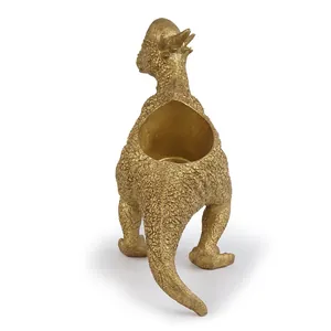 Back view detail of a gold resin dinosaur succulent planter showing textured finish