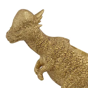 Detailed close-up of a golden resin Pachycephalosaurus dinosaur figurine ornament