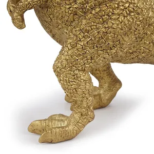 Detailed macro view of a golden resin dinosaur statue showing its scaly skin texture
