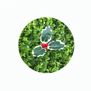 Macro detail of artificial Christmas holly leaves with vibrant red berries for festive DIY decor
