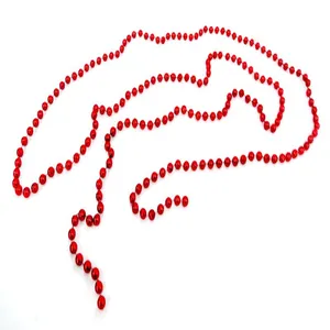 Macro view of a long red Christmas bead chain garland against a white background