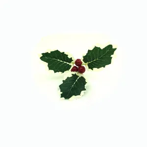 Close-up detail of artificial holly leaves with three red berries for Christmas DIY.