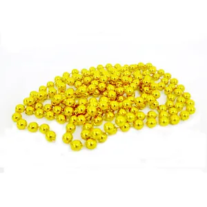 Detailed view of shiny golden bead chain for Christmas tree decoration and festive gifts