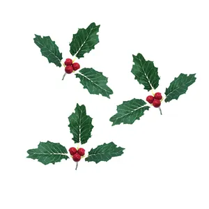Detailed view of artificial Christmas holly berries and green leaves ornaments