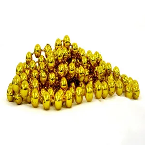 Close-up macro view of shiny metallic gold bead garland chain for Christmas tree decoration