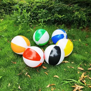 Six colorful 36cm inflatable beach balls scattered on a lush green grass field.