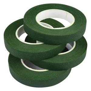 Close-up detail of four rolls of dark green floral tape for professional DIY flower wrapping.