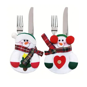 Detailed view of festive snowman-shaped cutlery holders with plaid scarf and heart
