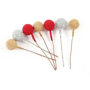 Close-up of artificial beaded berries in red gold and silver for Christmas DIY crafts