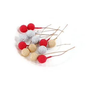 Close-up detail of red gold and silver artificial berries with beaded surface texture