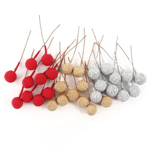 Detailed view of textured artificial berries in red, gold, and silver for DIY decor