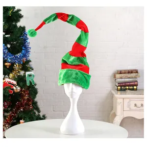 Detailed view of a long red and green striped plush elf hat in a festive setting
