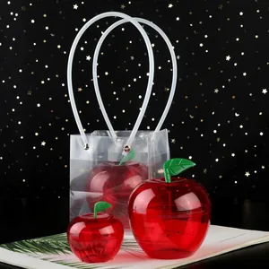 Red apple-shaped plastic candy box set with a transparent PVC gift handle bag