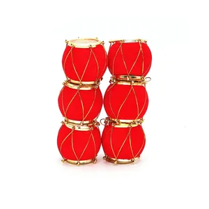 Detailed view of miniature red velvet Christmas drum ornaments with elegant gold trim