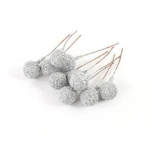Detailed macro view of artificial silver glitter berries for DIY Christmas decorations