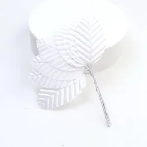 Close-up of white artificial silk leaves with detailed vein texture for DIY crafts