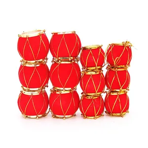 Set of red velvet Christmas drum ornaments with gold trim against a white backdrop