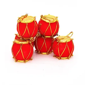 Detailed view of red velvet Christmas drum ornaments with golden trim for tree decoration