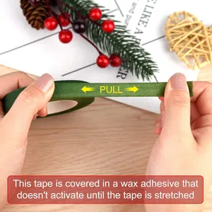 Hands stretching green floral tape to activate wax adhesive for DIY flower wrapping