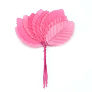 Detailed view of artificial pink leaves with wire stems for DIY wedding decor crafts.