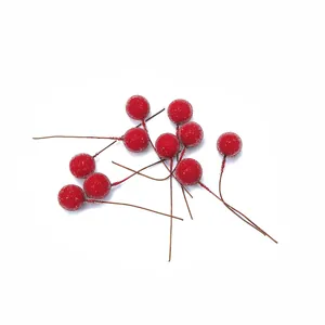 Close-up of artificial frosted red berries with wire stems for Christmas DIY decor.