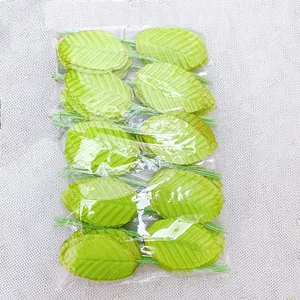 Detailed view of bulk green artificial rose leaves with wire stems for DIY wedding crafts