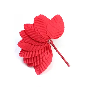 Close-up detail of vibrant red artificial rose leaves with wire stems for DIY craft
