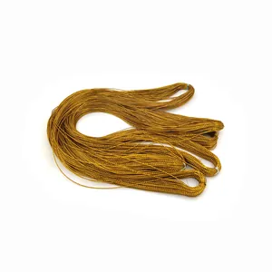 Macro detail view of a bundle of golden metallic thread for gift wrapping and tags