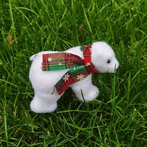 Close-up of white Christmas polar bear figurine with a festive red plaid scarf