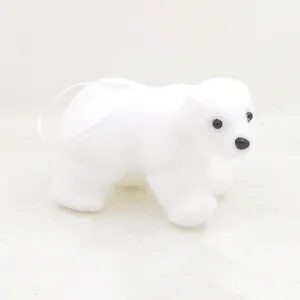 Detailed view of white fuzzy polar bear Christmas tree ornament with hanging ribbon loop