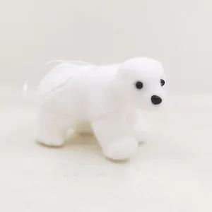 Detailed macro shot of a white fuzzy polar bear Christmas tree ornament with ribbon loop