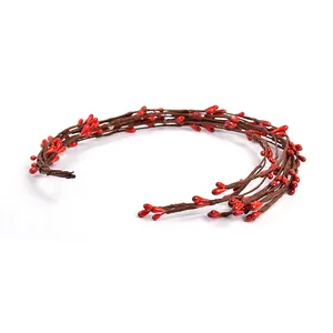 Detail view of a flexible red berry artificial vine for DIY home decor and crafts.