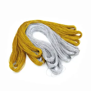 Detailed view of gold and silver metallic non-elastic gift packaging cords in bundles