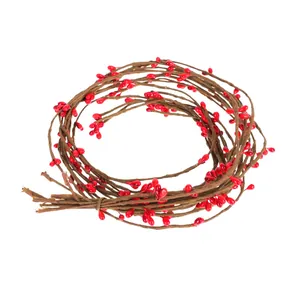 Detail showing the coiled structure of artificial brown vines with red berry pods
