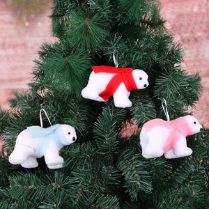Detail view of plush white polar bear Christmas tree ornaments with colorful scarves