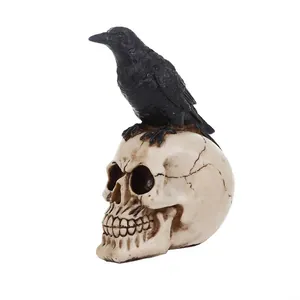 Detailed gothic resin Halloween skull statue with a realistic black crow perched on top.