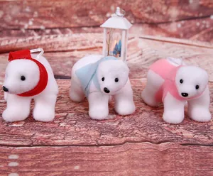 Set of three white flocked polar bear ornaments with colorful scarves for Christmas decor.
