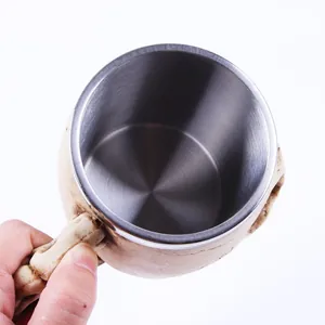 Top-down view showing the smooth stainless steel interior of the skull themed mug.