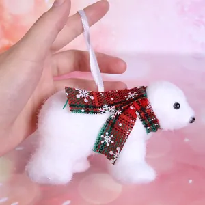Detail of white plush polar bear Christmas ornament with red plaid snowflake scarf